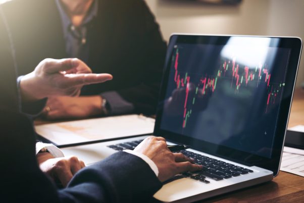 Business team investment working with computer and analysis graph stock market trading with stock chart data, business and technology concept.